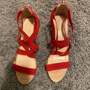 Size is a 9, heels are red with a cork textured heel. Has a gold zipper.